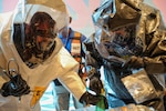 New York National Guard 2nd Civil Support Team Sgt. 1st Class Joshua Slish, decontamination noncommissioned officer, right, and Staff Sgt. Tyler Center, survey team chief, left, gather contaminated items during the certification process in Schenectady, N.Y. on June 11, 2026. The 2nd Civil Support Team based out of Stratton Air National Guard base is one of two New York National Guard Civil Support Teams. These teams are required to be federally certified every 18 months. Photo by Stephanie Butler.