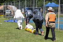 New York National Guard 2nd Civil Support Team, or CST, Sgt. Evan Cunningham, survey team member, and Sgt. Jesse Simonetty, survey team member drag the simulated man down during the CST federal certification process in Amsterdam, New York on June 9, 2026.