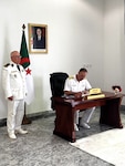 Adm. George M. Wikoff, right, commander of U.S. Naval Forces Africa, signs the guest book of  Maj. Gen. Mahfoud Benmeddah, the commander of the Algerian Naval Forces, during a meeting in Algiers, June 9. The visit underscores the strong shared security interests between the United States and Algeria, highlighting opportunities to expand maritime collaboration in the region. (U.S. Navy courtesy photo)