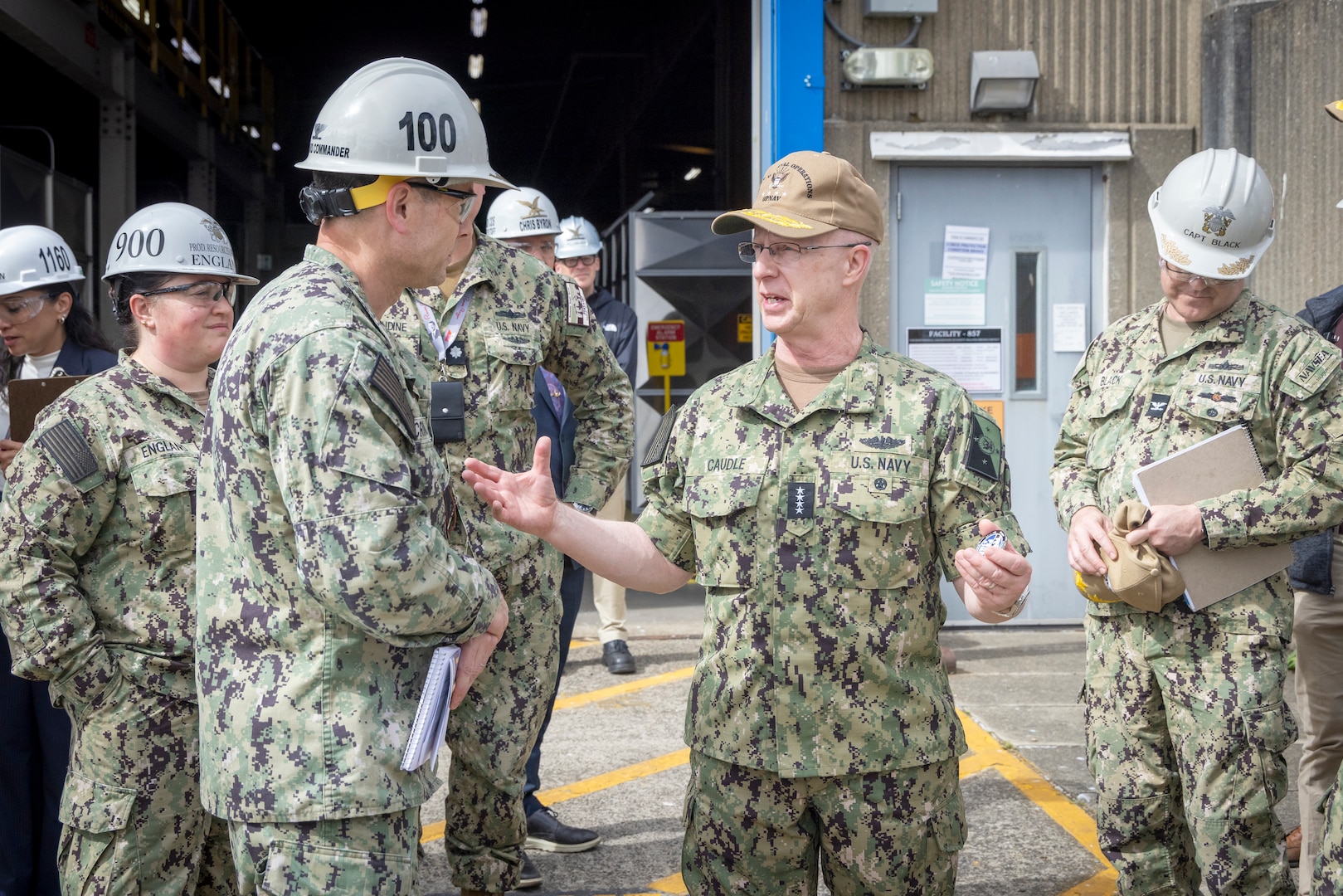 Chief of Naval Operations Adm. Daryl Caudle and Capt. JD Crinklaw, commander, Puget Sound Naval Shipyard & Intermediate Maintenance Facility, exchange command coins at the conclusion of the CNO's visit, June 3, 2026, in Bremerton, Washington. (U.S. Navy photo by Wendy Hallmark)