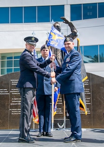 Col. Andrew C. Dermanoski, left, commander of Space Base Delta 3, presents the 61st Security Forces Squadron guidon to Capt. Joshua D. Baird, incoming commander of the 61st Security Forces Squadron, during a change of command ceremony at Los Angeles Air Force Base, California, June 12, 2026. The passing of the guidon represents Baird's assumption of command of the squadron. The 61st Security Forces Squadron provides security and force protection for four installations, supports Space Systems Command's $10 billion acquisition mission and serves more than 600 military families. (U.S. Space Force photo by Van Ha)