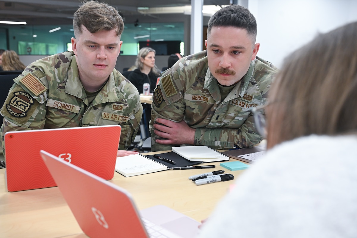 Kessel Run 1st Lt. Aaron Schmidt and 1st Lt. Larry Mercier get hands-on training with the future of software development during a two-day course meant to teach them the intricacies of AI, June 3. Airmen and government civilians in leadership and functional positions trained to build software applications capable of solving real-world problems. Schmidt is a program manager and Mercier is an executive officer. (Official Air Force photo by Richard Blumenstein).