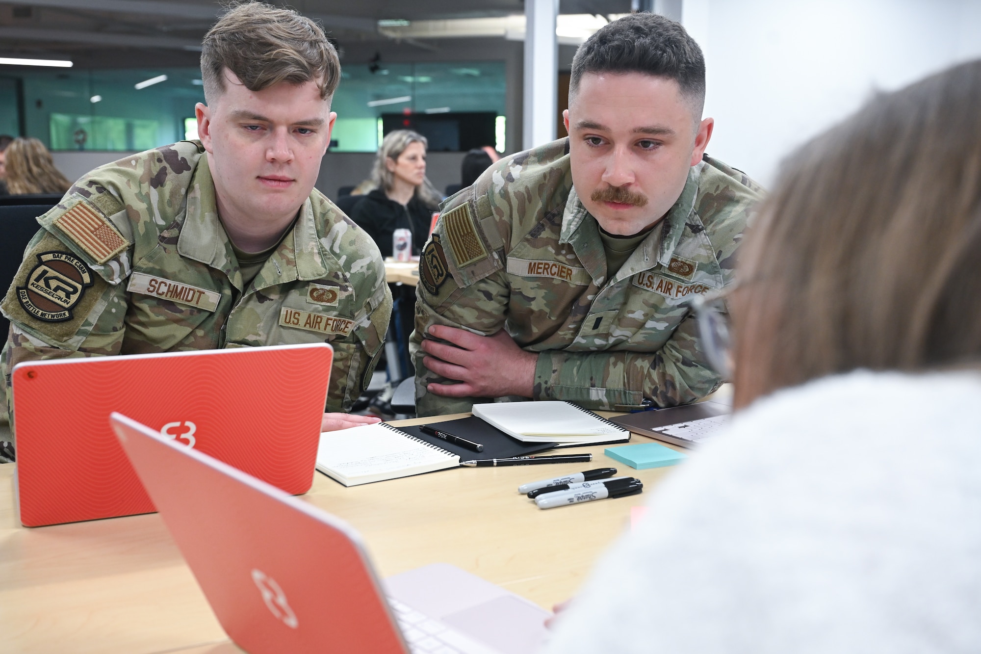 Kessel Run 1st Lt. Aaron Schmidt and 1st Lt. Larry Mercier get hands-on training with the future of software development during a two-day course meant to teach them the intricacies of AI, June 3. Airmen and government civilians in leadership and functional positions trained to build software applications capable of solving real-world problems. Schmidt is a program manager and Mercier is an executive officer. (Official Air Force photo by Richard Blumenstein).