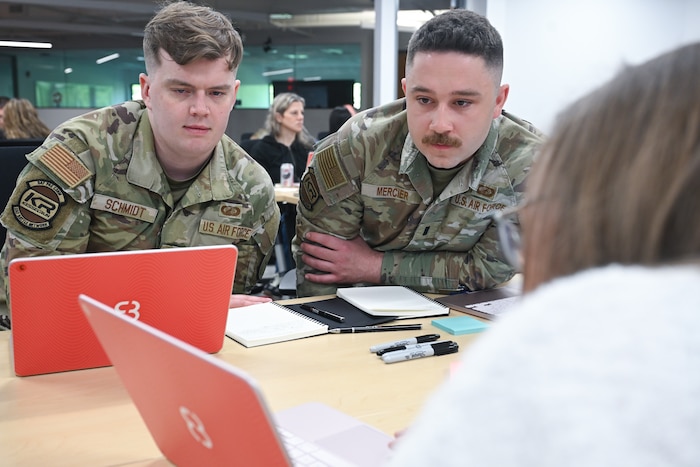 Kessel Run 1st Lt. Aaron Schmidt and 1st Lt. Larry Mercier get hands-on training with the future of software development during a two-day course meant to teach them the intricacies of AI, June 3. Airmen and government civilians in leadership and functional positions trained to build software applications capable of solving real-world problems. Schmidt is a program manager and Mercier is an executive officer. (Official Air Force photo by Richard Blumenstein).