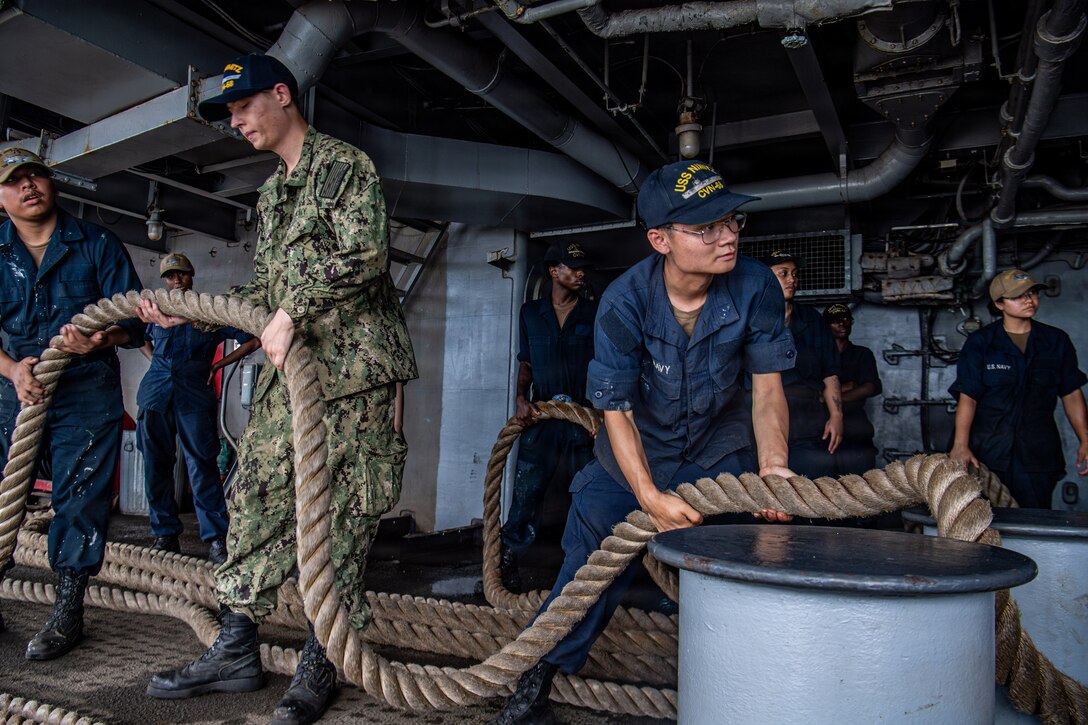 Sailors handle line on the fantail of Nimitz-class aircraft carrier USS Nimitz (CVN 68) while  pulling into Naval Station Mayport in Jacksonville, Florida, June 16, 2026. USS Nimitz is underway in the U.S. 2nd Fleet area of operations as part of a scheduled homeport shift to Norfolk, Virginia. (U.S. Navy photo by Mass Communication Specialist Seaman Tanner Orth)