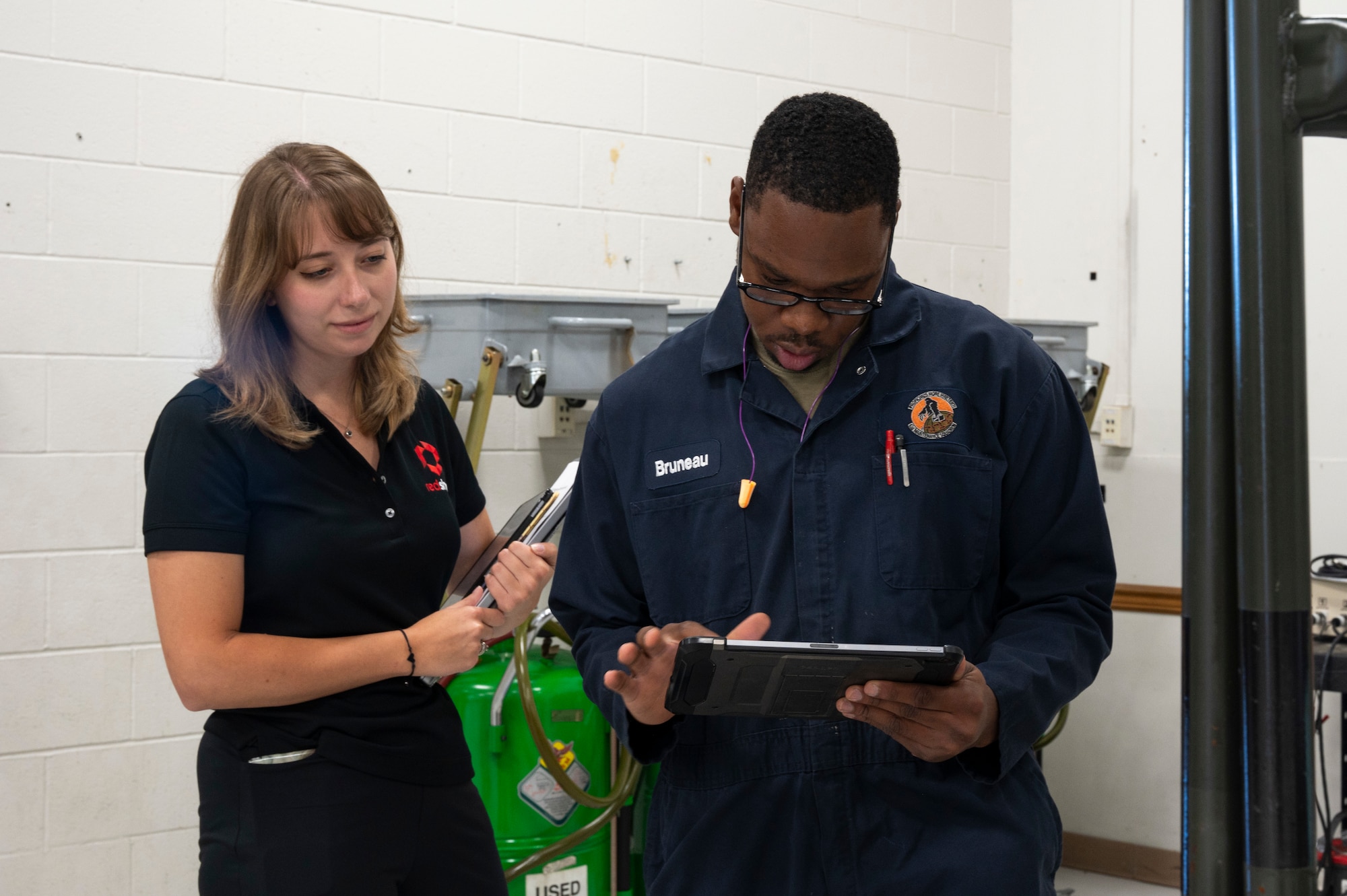 A man and a woman looking at an iPad.