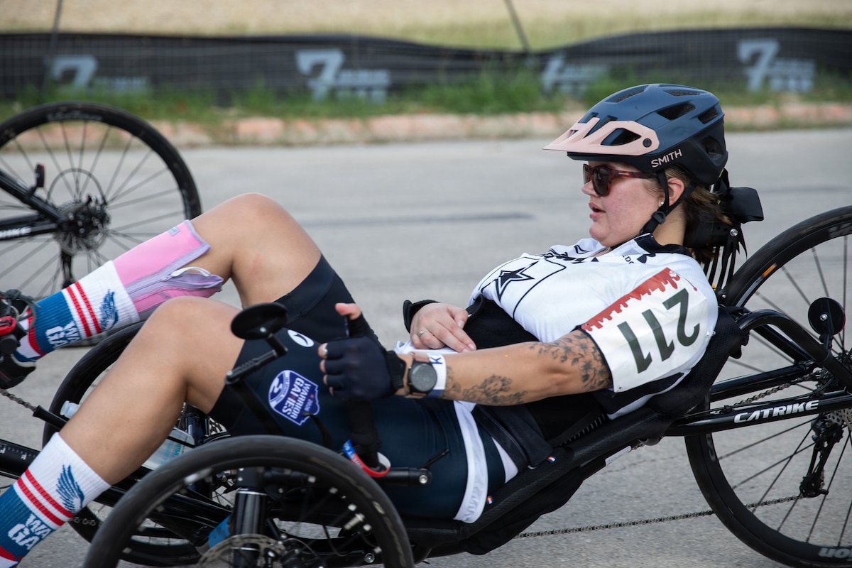 An athlete operates a recumbent bicycle.