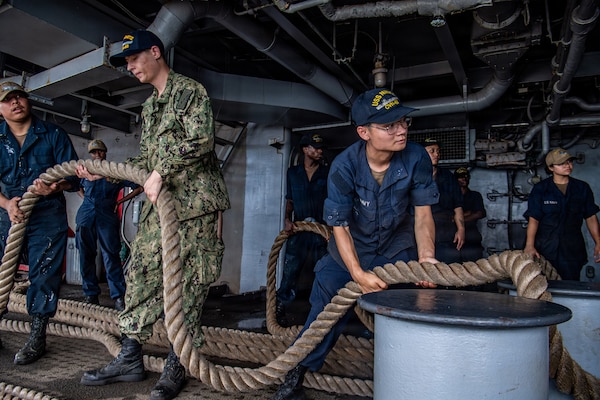 Sailors handle line on the fantail of Nimitz-class aircraft carrier USS Nimitz (CVN 68) while  pulling into Naval Station Mayport in Jacksonville, Florida, June 16, 2026. USS Nimitz is underway in the U.S. 2nd Fleet area of operations as part of a scheduled homeport shift to Norfolk, Virginia. (U.S. Navy photo by Mass Communication Specialist Seaman Tanner Orth)