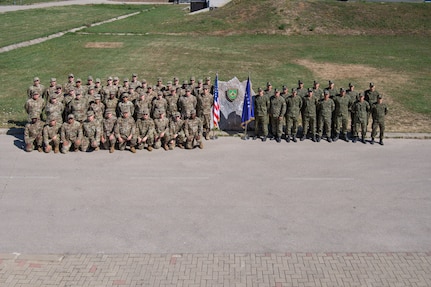 Iowa Air National Guard communication Soldiers and Airmen pose for a group photo alongside Kosovo Security Force communications soldiers during Exercise Sentinel Sica in Kosovo, June 11, 2026.