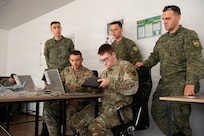 Iowa Air National Guard communication Airmen work to establish network connectivity while being observed by Kosovo Security Force communications soldiers during Exercise Sentinel Sica in Kosovo, June 9, 2026.