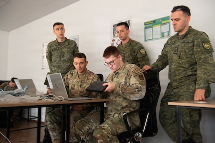 Iowa Air National Guard communication Airmen work to establish network connectivity while being observed by Kosovo Security Force communications soldiers during Exercise Sentinel Sica in Kosovo, June 9, 2026.