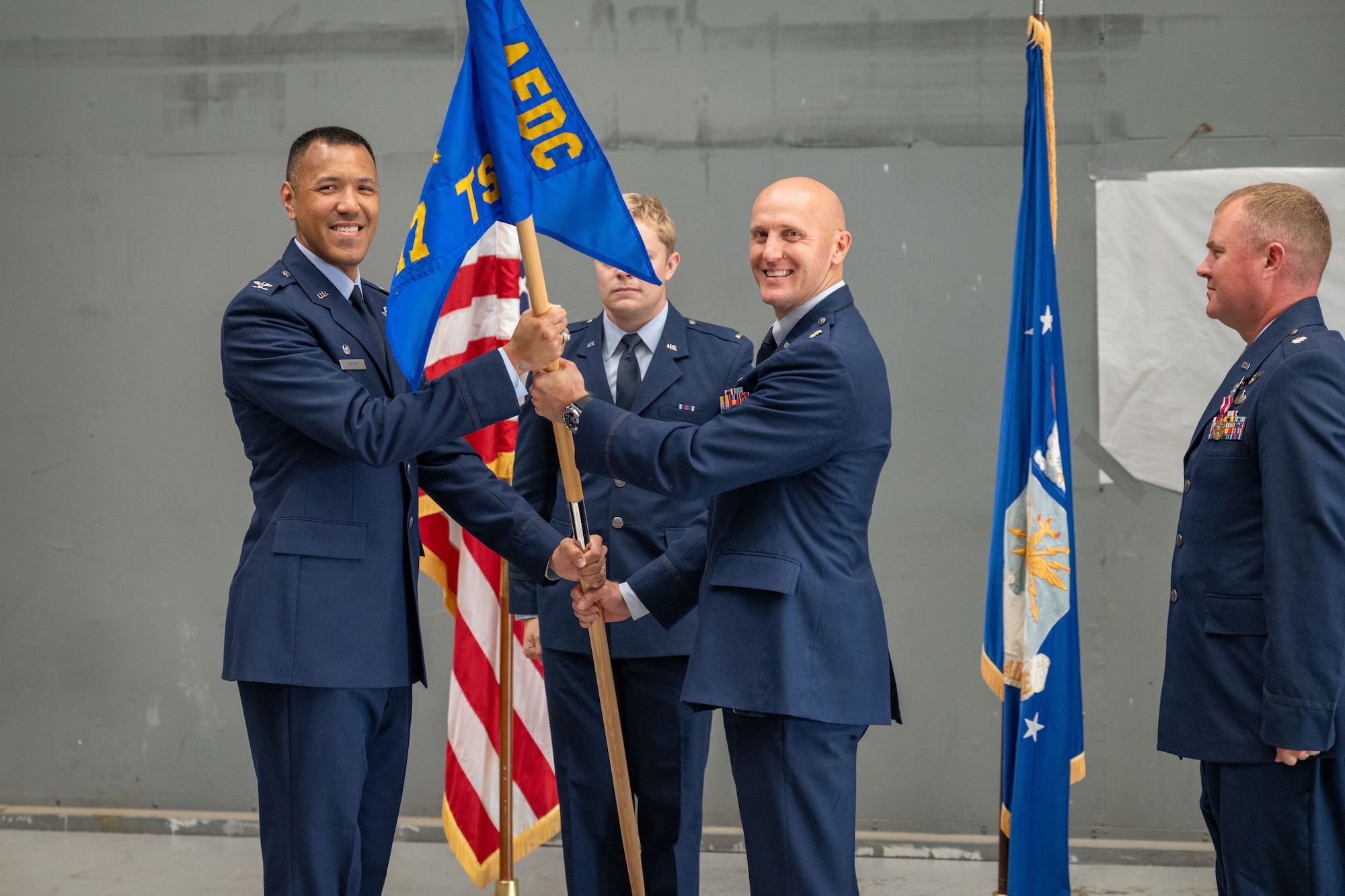 Lt. Col. Jonathan Tellefsen, center, takes the guidon from 804th Test Group Commander Col. Jack Rhodes, left, to assume the role of 717th Test Squadron commander during a June 9, 2026, Change of Leadership ceremony at Arnold Air Force Base, Tenn., headquarters of Arnold Engineering Development Complex. Also pictured is outgoing 717 TS Commander Lt. Col. Joshua Thomas. (U.S. Air Force photo by Keith Thornburgh)