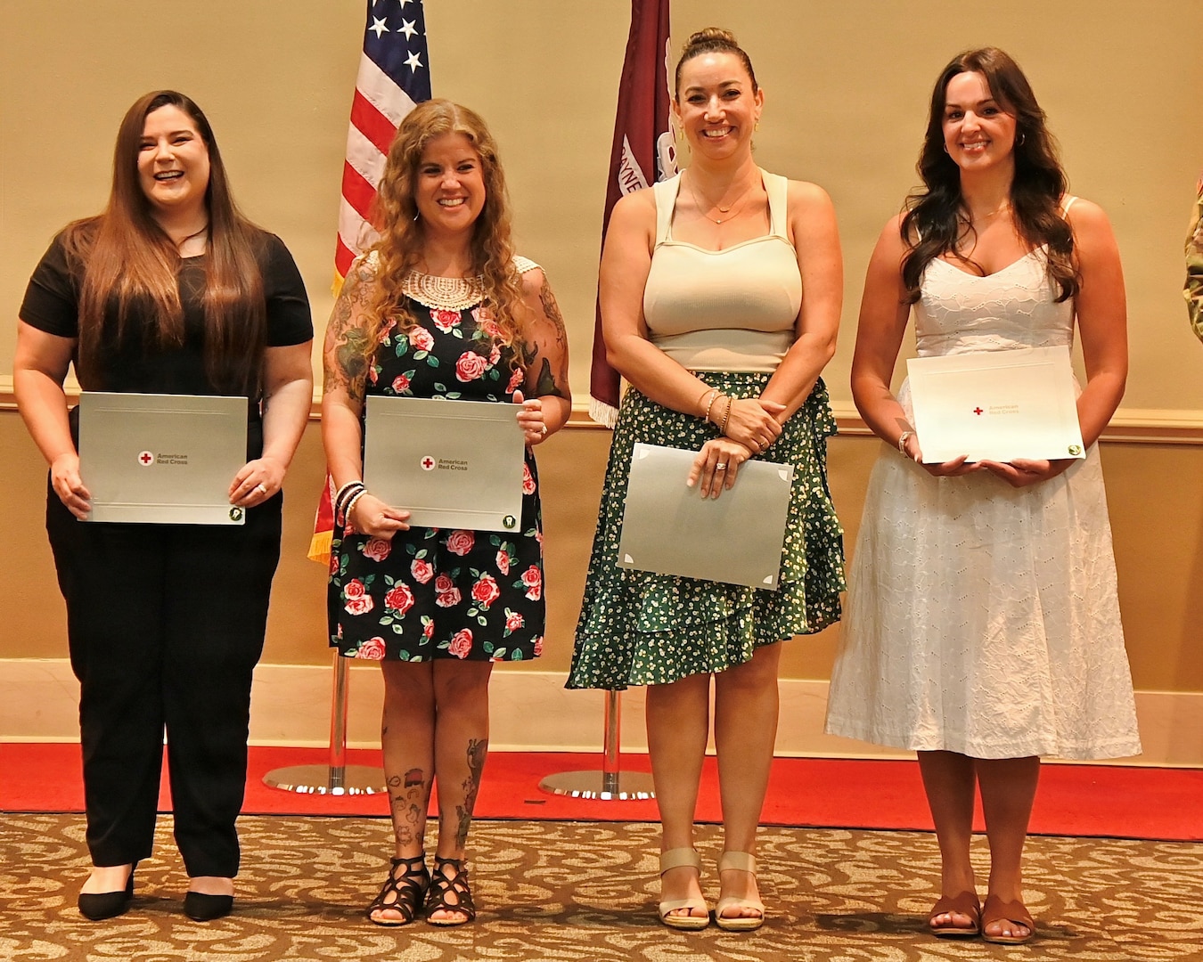 Four graduates of the Dental Assistant Program pose with diplomas.