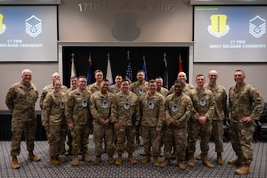 U.S. Air Force technical sergeants assigned to the 17th Training Wing pose for a group photo with Col. Matthew Norton, 17th TRW commander, and Chief Master Sgt. Derek Neill, 17th TRW command chief, after a master sergeant release party at the Powell Event Center, Goodfellow Air Force Base, Texas, June 16, 2026. Promotion to master sergeant marks an Airman's first step into assuming a senior noncommissioned officer's duties. (U.S. Air Force photo by Senior Airman Brian Lummus)