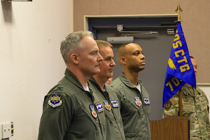 photo of three USAF Airmen standing at attention