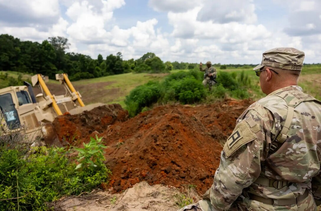 First Army Soldiers provide OC/T support to U.S. Army Reserve engineers as they construct a fighting position during Operation Sentinel Justice.