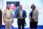 WASHINGTON, DC (June 11, 2026) - Vice Admiral Jim Downey, Commander, Naval Sea Systems Command (NAVSEA) and Ms. Leslie Joseph, Deputy Commander, Total Force and Corporate Operations, hosted the NAVSEA Excellence Awards in the auditorium. The 2025 NAVSEA Excellence in Acquisition Award is presented to Mr. Michael J. Campbell (center).