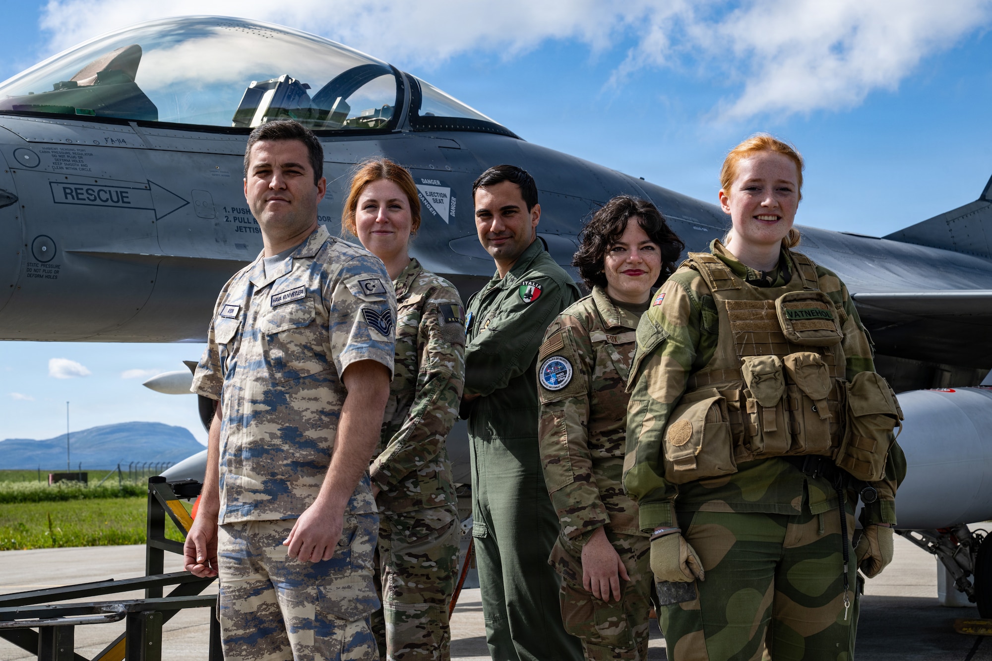 U.S., Norwegian, Italian, Turkish, and Belgium Airmen pose for a photo by a Belgium F-16 Fighting Falcon during Ramstein Flag 26 at Ørland Air Base, Norway, June 17, 2026.