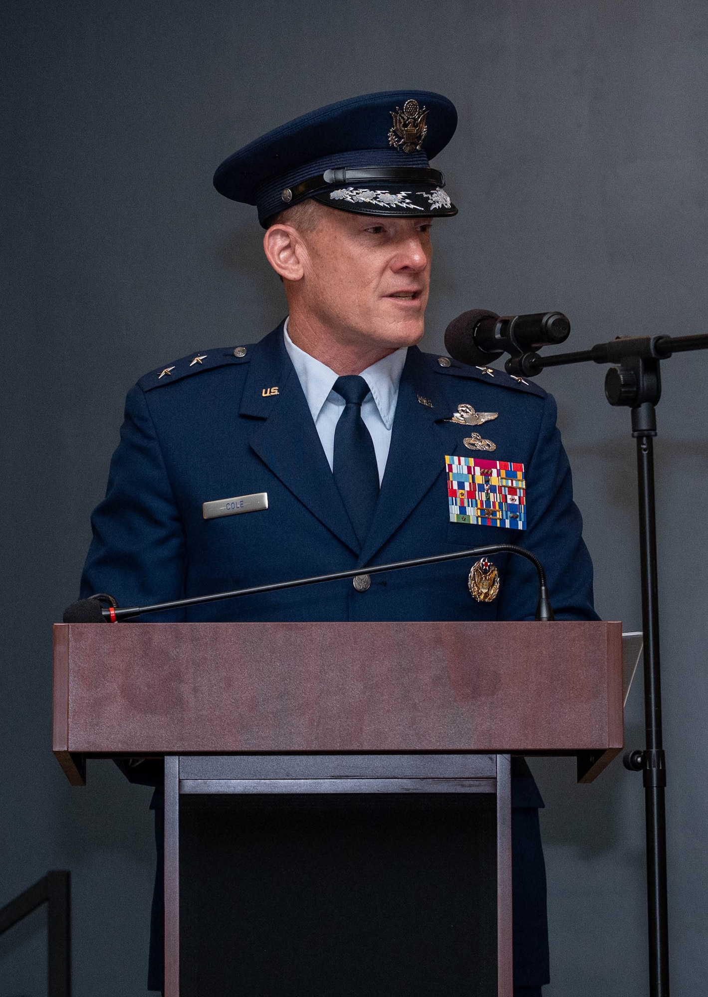 A man in uniform stands at a podium and gives a speech.
