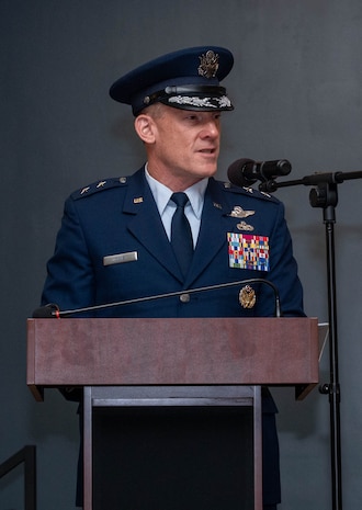 A man in uniform stands at a podium and gives a speech.