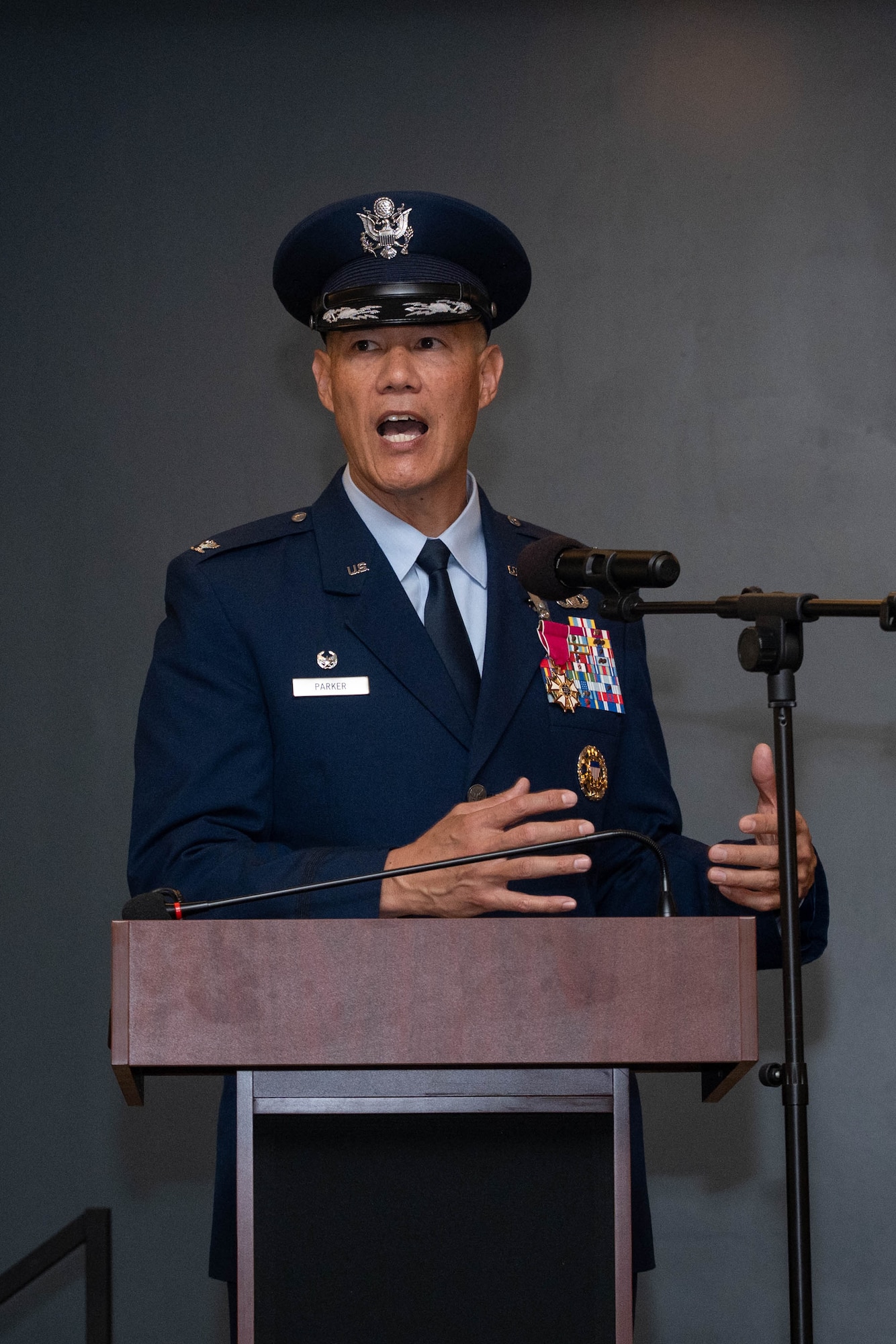 A man in uniform stands at a podium and gives a speech.