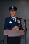 A man in uniform stands at a podium and gives a speech.
