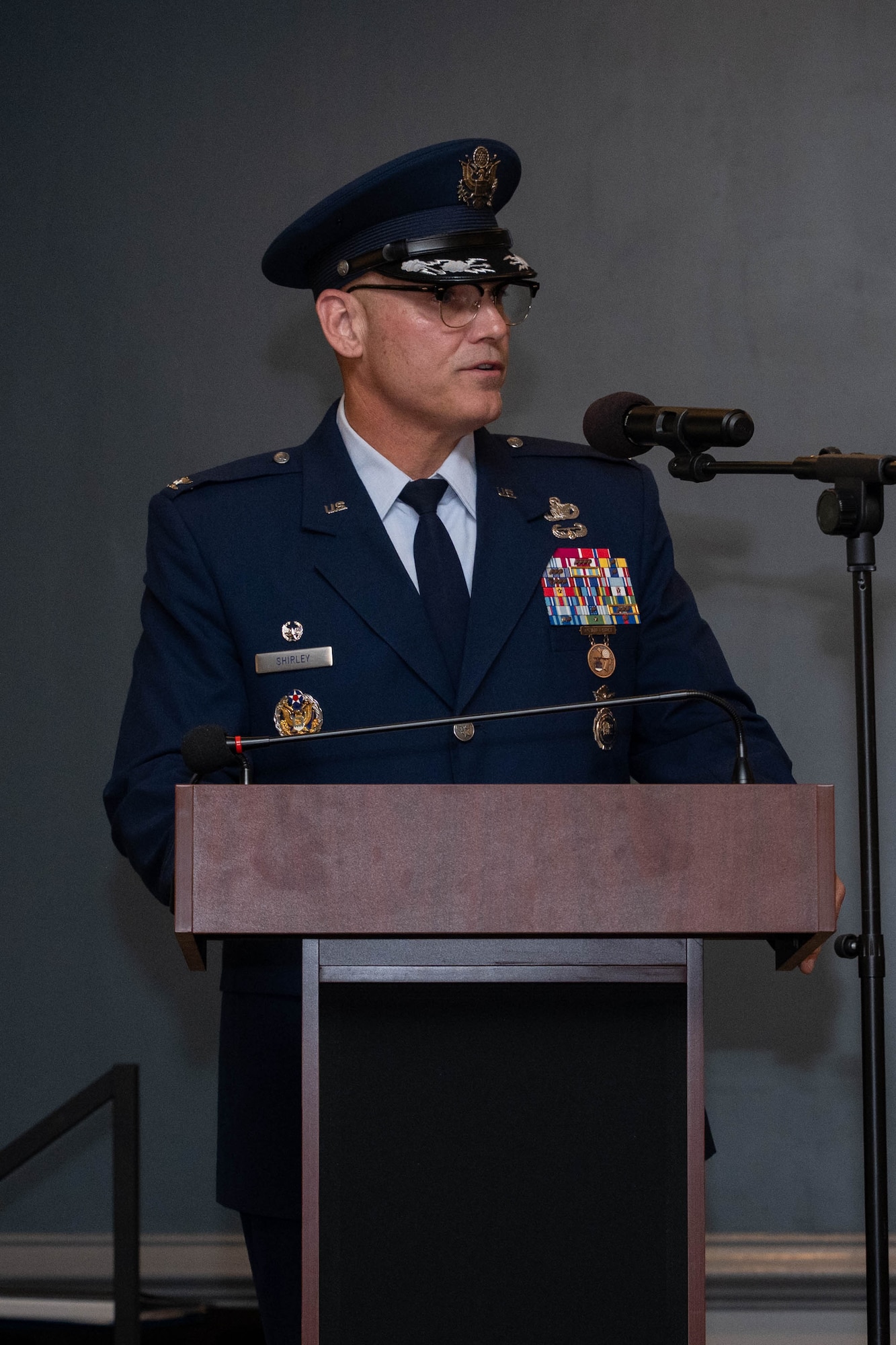 A man in uniform gives a speech at a podium