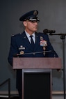 A man in uniform gives a speech at a podium