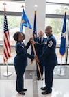 Chief Master Sgt. Marcus D. Washington, outgoing command chief of the 59th Medical Wing, passes the guidon to Brig. Gen. Gwendolyn A. Foster, commander of the 59th Medical Wing, during a Change of Responsibility Ceremony at the Wilford Hall Ambulatory Surgical Center, Joint Base San Antonio-Lackland, Texas, June 12, 2026.