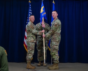 U.S. Air Force Col. Darryl Hebert, 56th Mission Support Group commander, left, receives the unit guidon from Lt. Col. Chris Bahrij, 13th Combat Air Base Squadron commander, during the squadron's inactivation ceremony at Luke Air Force Base, Arizona, June 16, 2026.