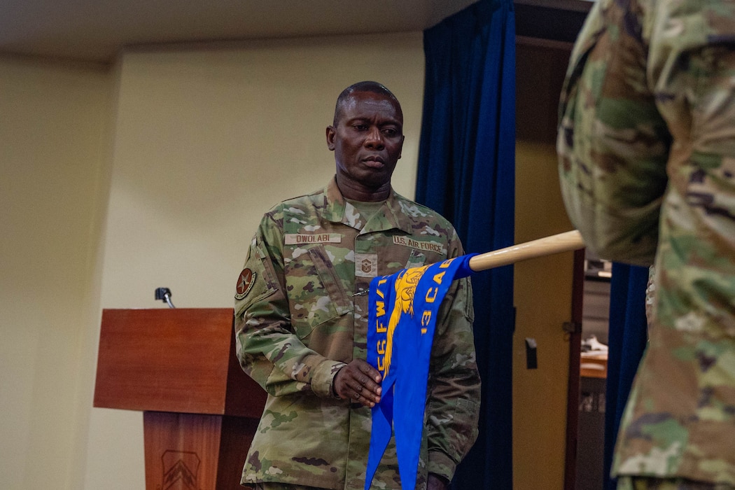 U.S. Air Force Senior Master Sgt. Olufemi Owolabi, 13th Combat Air Base Squadron first sergeant, cases the unit guidon during the squadron's inactivation ceremony at Luke Air Force Base, Arizona, June 16, 2026.
