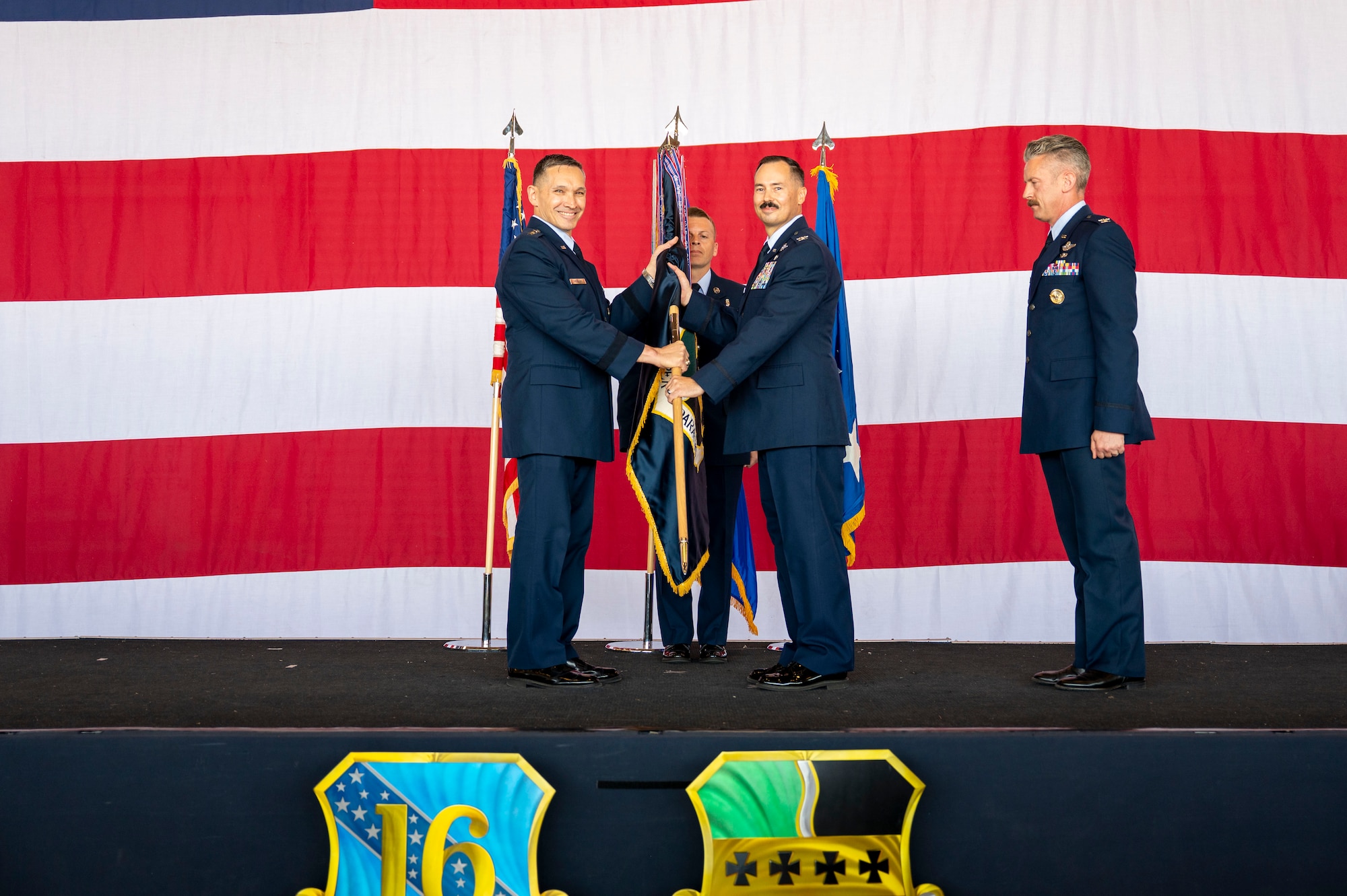 U.S. Air Force Lt. Gen. Thomas Hensley, commander of the Sixteenth Air Force, transfers the 9th Reconnaissance Wing guidon staff to Col. Geoffrey Cameron, 9th RW incoming commander, during the 9th RW change of command ceremony at Beale Air Force Base, California, June 17, 2026.