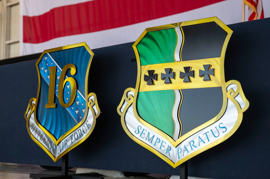 The Sixteenth Air Force and 9th Reconnaissance Wing heraldic emblems rest against the stage during the 9th RW change of command ceremony at Beale Air Force Base, California, June 17, 2026.