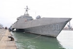 Sri Lanka Navy Rear Adm. Jagath Kumara, commander, Western Naval Area, salutes the watch as he arrives aboard Independence-variant littoral combat ship USS Canberra (LCS 30). Canberra is conducting routine operations in the U.S. 7th Fleet area of operations. (U.S. Navy photo by Operations Specialist 1st Class Anthony Wade).