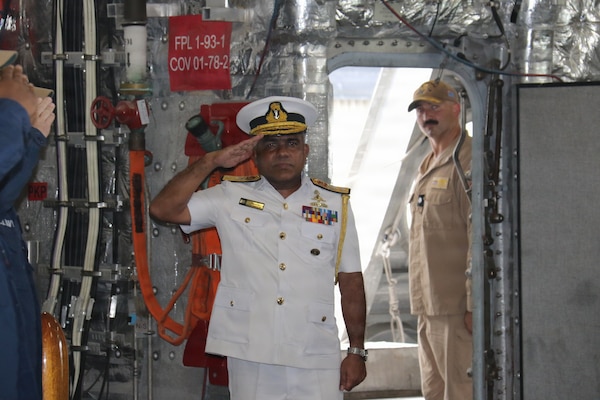 Sri Lanka Navy Rear Adm. Jagath Kumara, commander, Western Naval Area, salutes the watch as he arrives aboard Independence-variant littoral combat ship USS Canberra (LCS 30). Canberra is conducting routine operations in the U.S. 7th Fleet area of operations. (U.S. Navy photo by Operations Specialist 1st Class Anthony Wade).