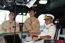 From left, Cmdr. James McLaughlin, commanding officer of Independence-variant littoral combat ship USS Canberra (LCS 30), Cmdr. Ryan Griffith, executive officer of Canberra, and Sri Lanka Navy Rear Adm. Jagath Kumara, commander, Western Naval Area, pose for a photo on the ship’s bridge. Canberra is conducting routine operations in the U.S. 7th Fleet area of operations. (U.S. Navy photo by Operations Specialist 1st Class Anthony Wade).