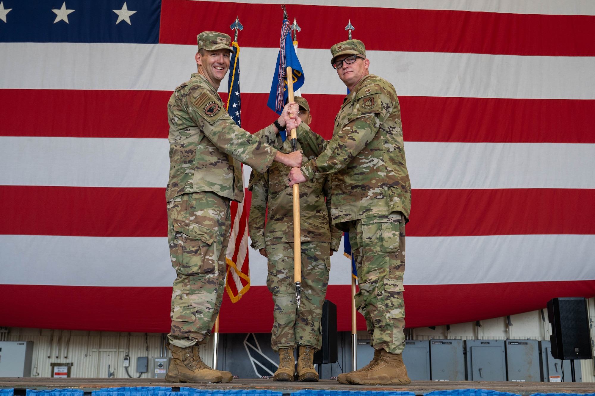 U.S. Air Force Col. John DeLion, left, 8th Fighter Wing commander, passes the 8th Medical Group guidon to Col. Joshua Miller, incoming 8th MDG commander, during an assumption of command ceremony at Kunsan Air Base, Republic of Korea, June 24, 2026. The 8th MDG provides preventive health services and outpatient medical care to more than 2,800 base personnel. (U.S. Air Force photo by Staff Sgt. Cedrique Oldaker)