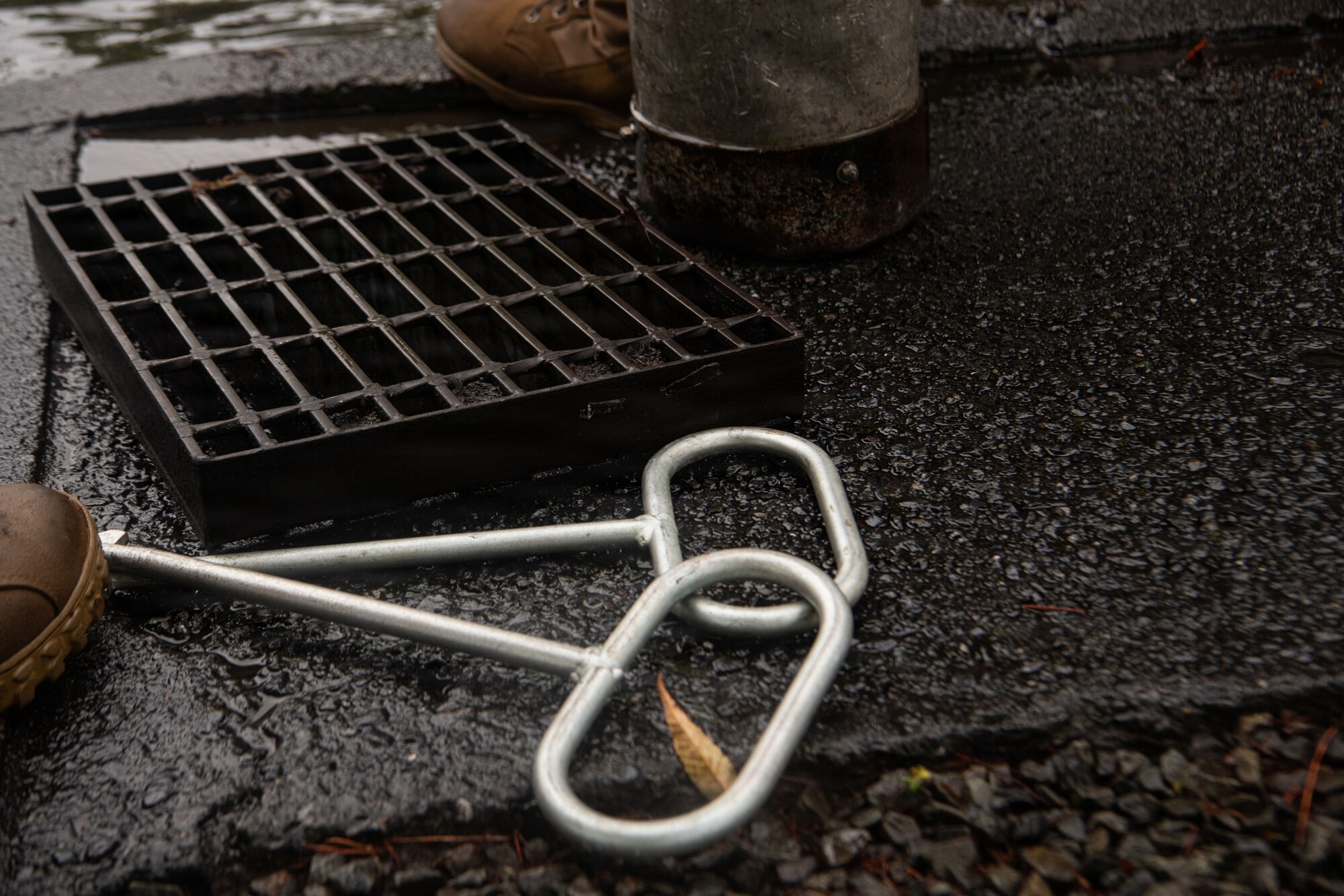 The cover of a drain is removed to be unclogged.