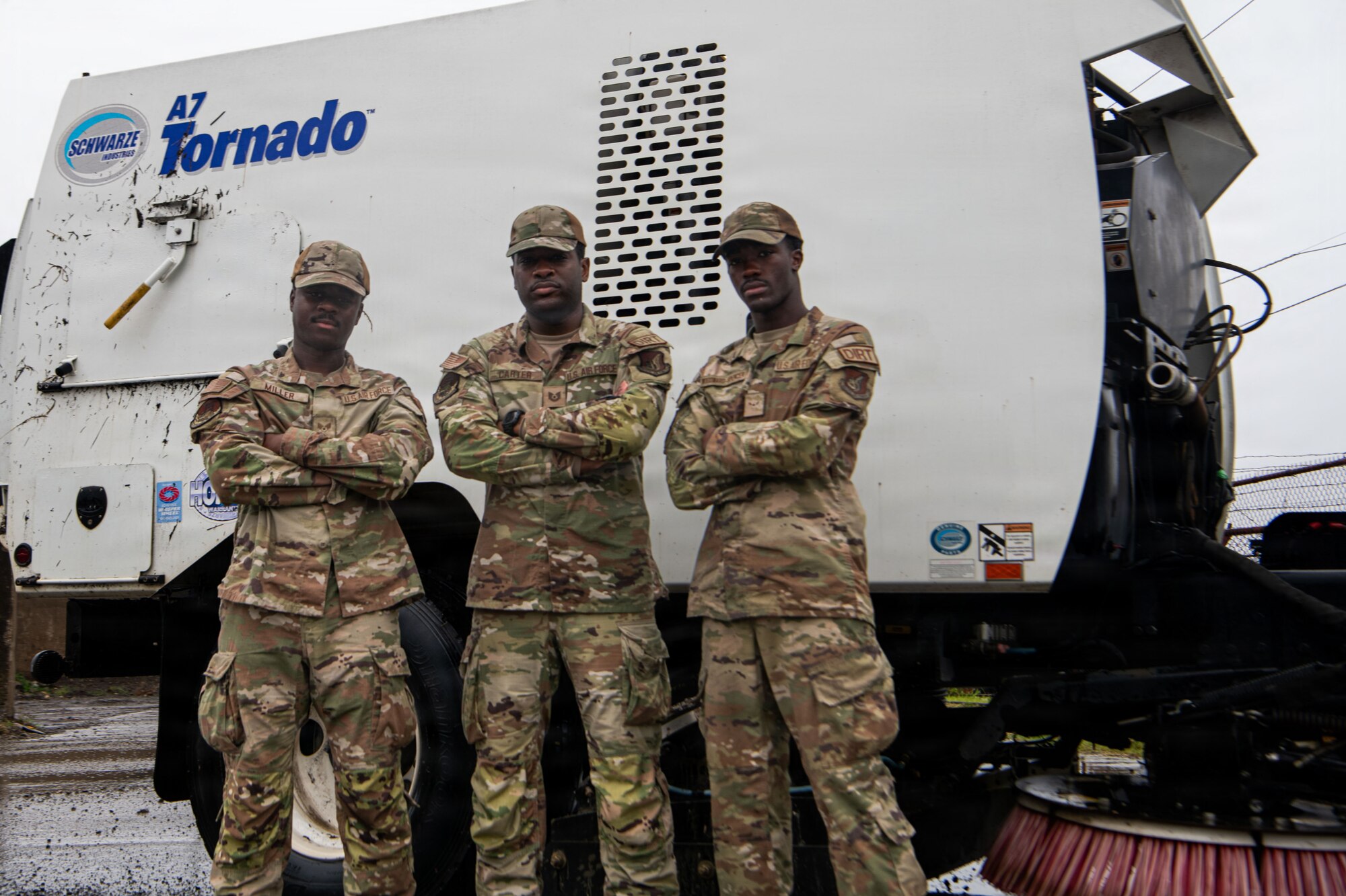 A Tech Sgt. and two Airmen pose for a group photo.