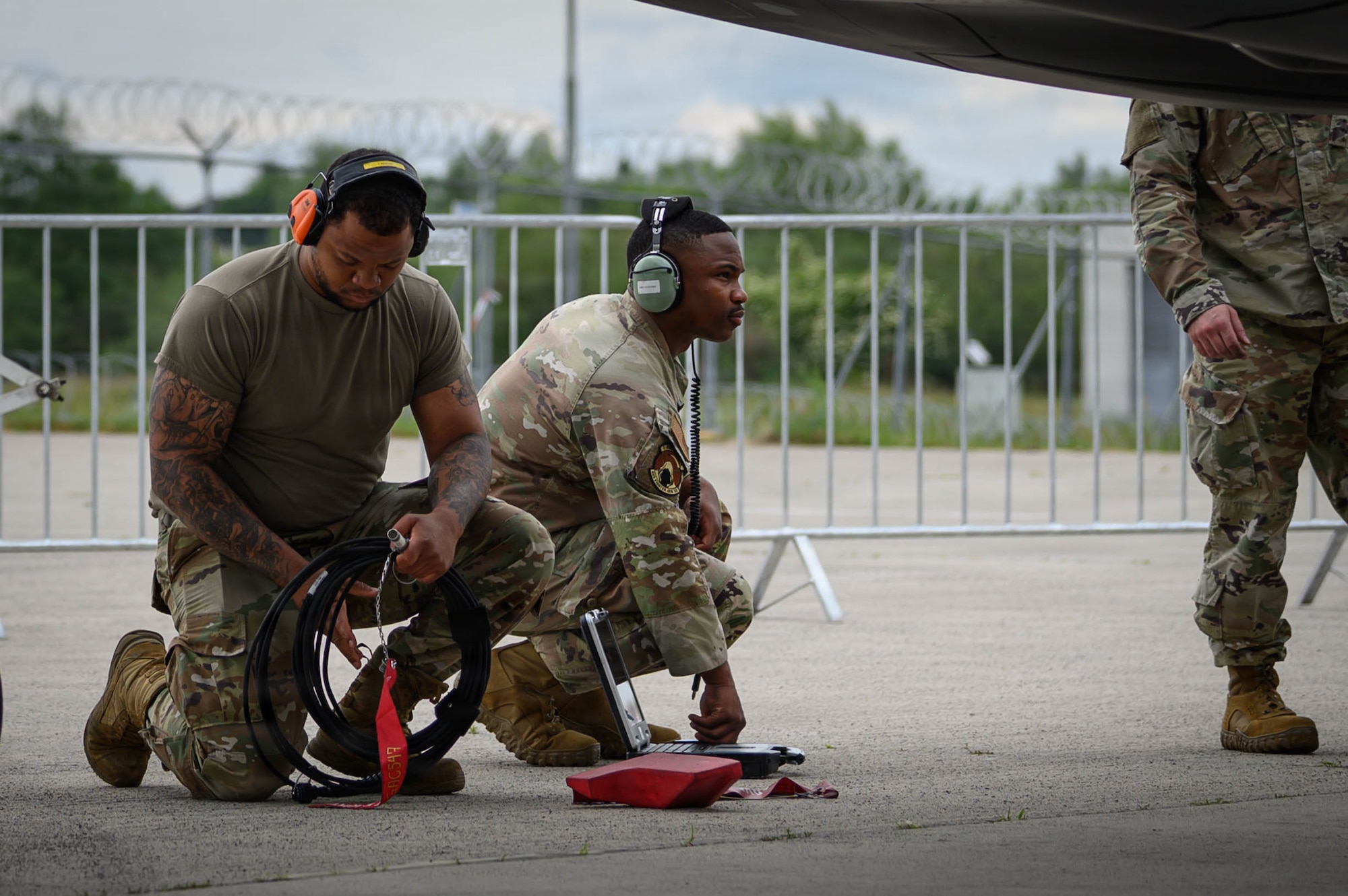U.S. Air Force Senior Airman Joshua Miller, 493rd Fighter Generation Squadron F-35 dedicated crew chief, left, and Staff Sgt. Lucien Anderson, 493rd FGS F-35 dedicated crew chief, conduct post-flight procedures on an F-35A Lightning II following its arrival for the ILA Berlin Air Show June 9, 2026, at Berlin-Brandenburg Airport, Germany.
