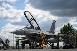 U.S. Air Force and German military crew members conduct post-flight checks on an F-16D Fighting Falcon assigned to the 31st Fighter Wing before the ILA Berlin Air Show June 9, 2026, at Berlin-Brandenburg Airport, Germany.