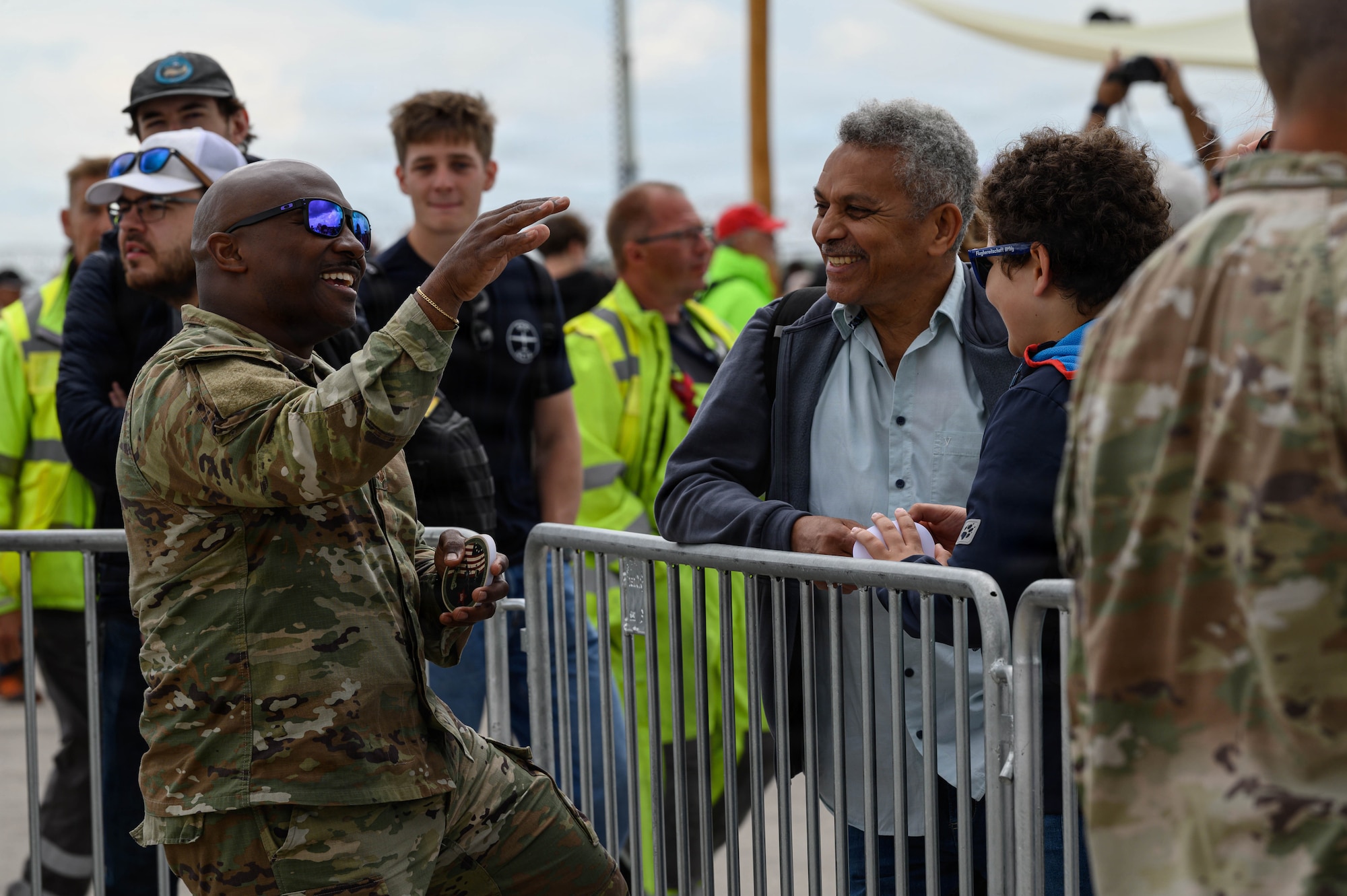 U.S. Air Force Master Sgt. Julius Paster, Air Force Installation Mission Support Center/Detachment 4 manager of the operations branch, left, speaks with visitors during the ILA Berlin Air Show June 13, 2026, at Berlin-Brandenburg Airport, Germany.