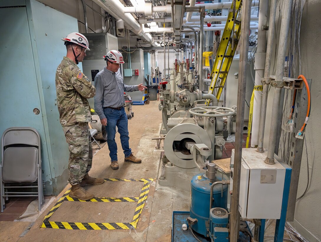 U.S. Army Corps of Engineers Wilmington District Commander Col. Brad Morgan, right, and Steve Jones, chief of hydropower, observe Unit 2 from the generator bay floor during a visit to the Philpott Dam powerhouse in Virginia, April 2026. The inspection supports ongoing rehabilitation efforts to modernize the facility’s hydropower infrastructure.