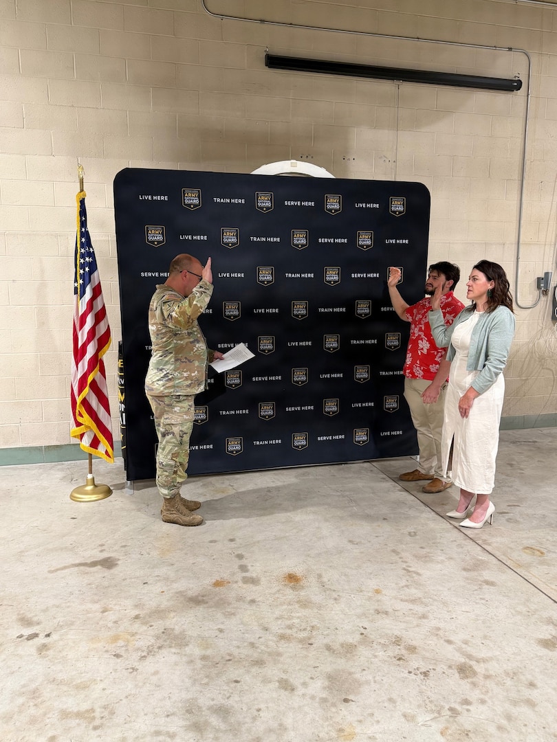 Katherine and Matthew Zito raise their right hands during their enlistment swearing-in as Maj. Andrew Line swears them into the Pennsylvania Army National Guard in Gettysburg, Pennsylvania, June 12, 2026.