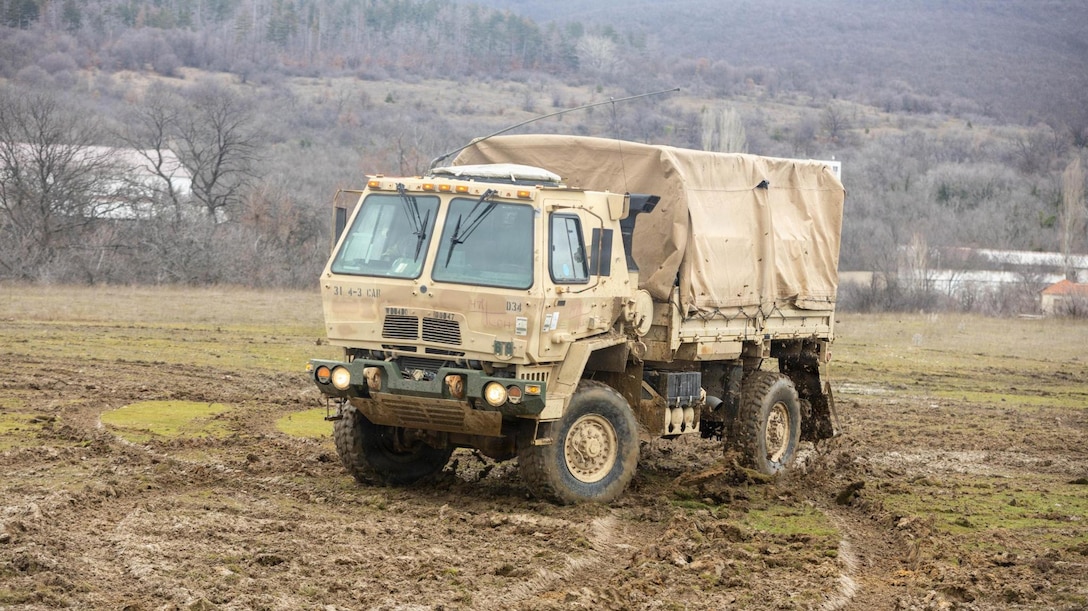Light Medium Tactical Vehicle (LMTV) drives through the mud.