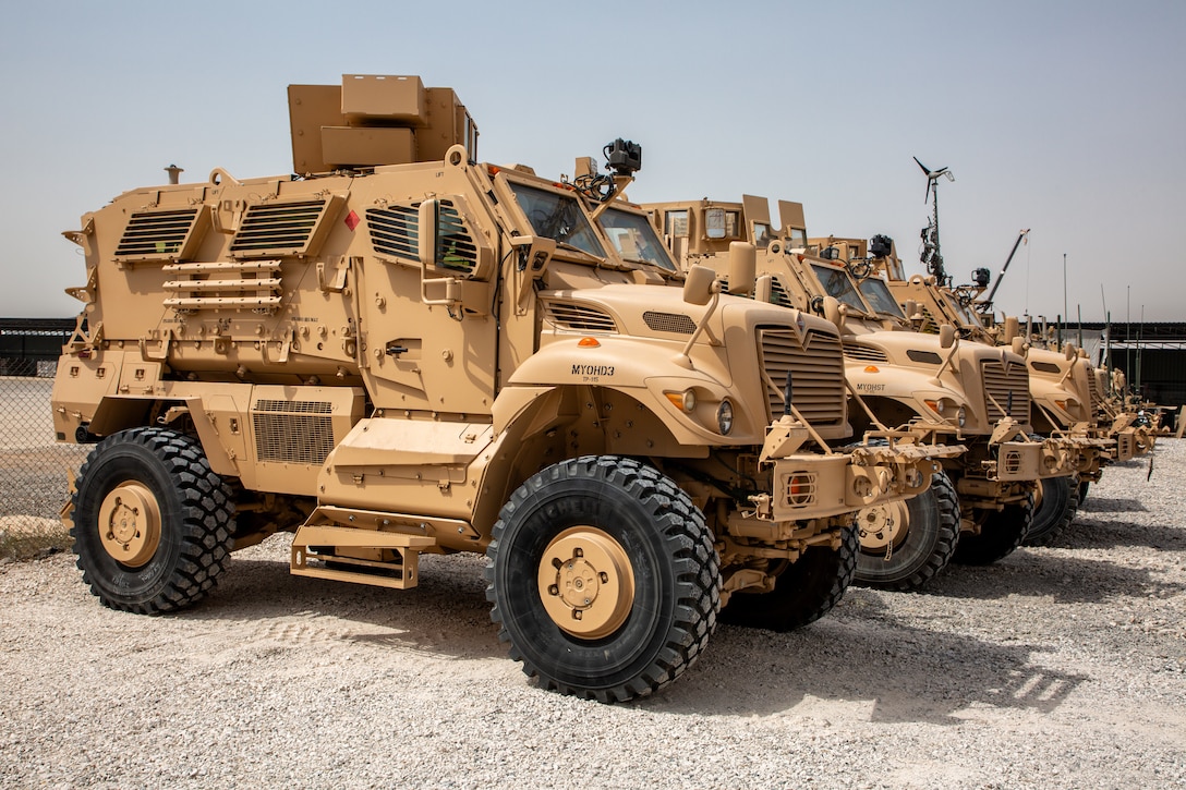 M1224 MaxxPro Mine-Resistant Ambush Protected vehicles  are in a row at a motor pool.