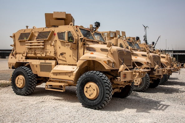 M1224 MaxxPro Mine-Resistant Ambush Protected vehicles sit in a row at a motor pool.