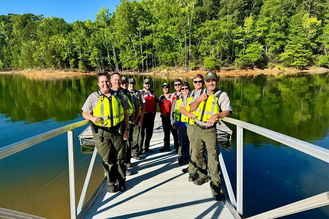 Park Rangers wearing life jackets on a boat dock.