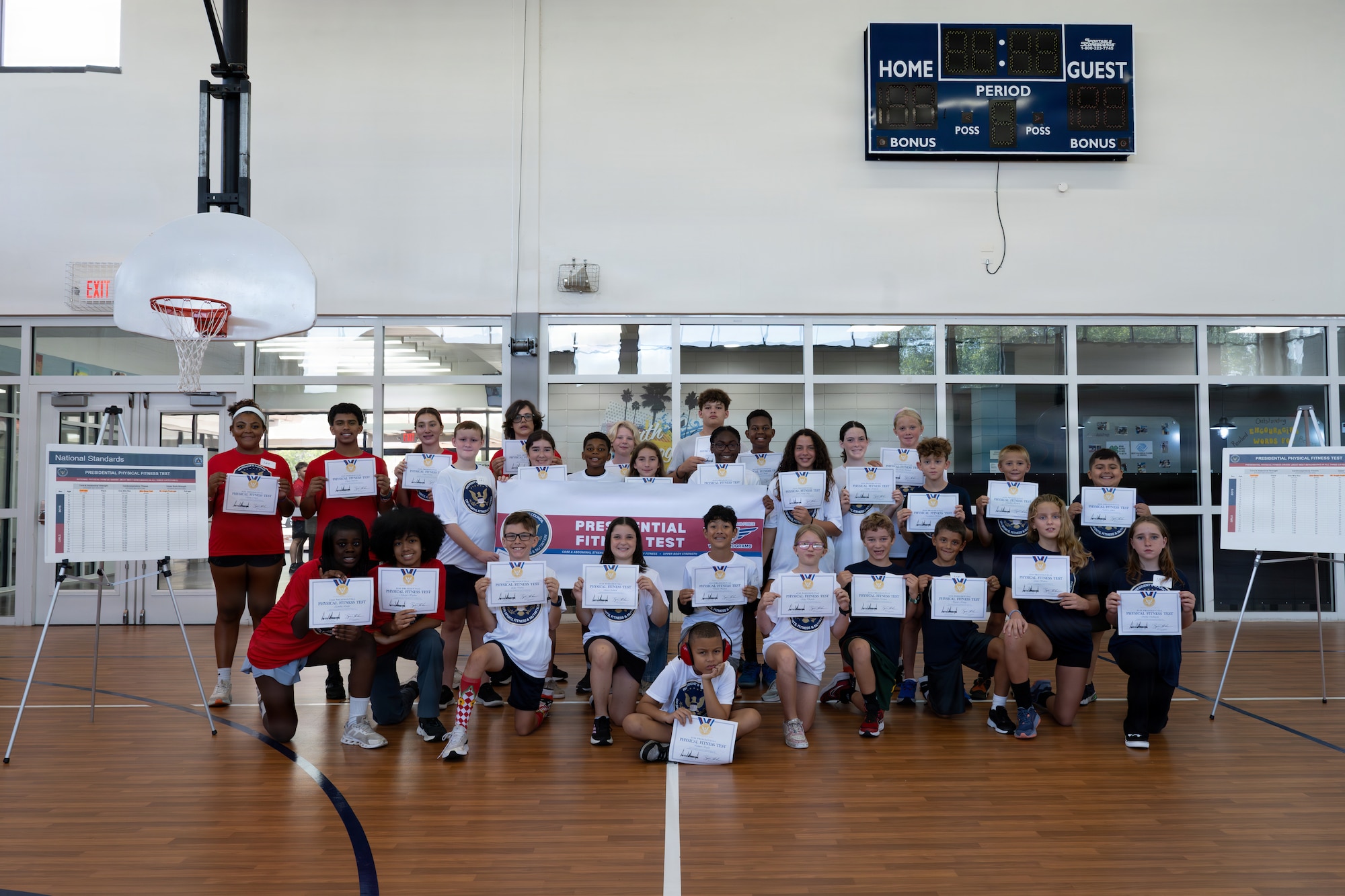Military children pose for a photo displaying their Presidential Physical Fitness Test certificates at MacDill Air Force Base, Florida, June 12, 2026.
