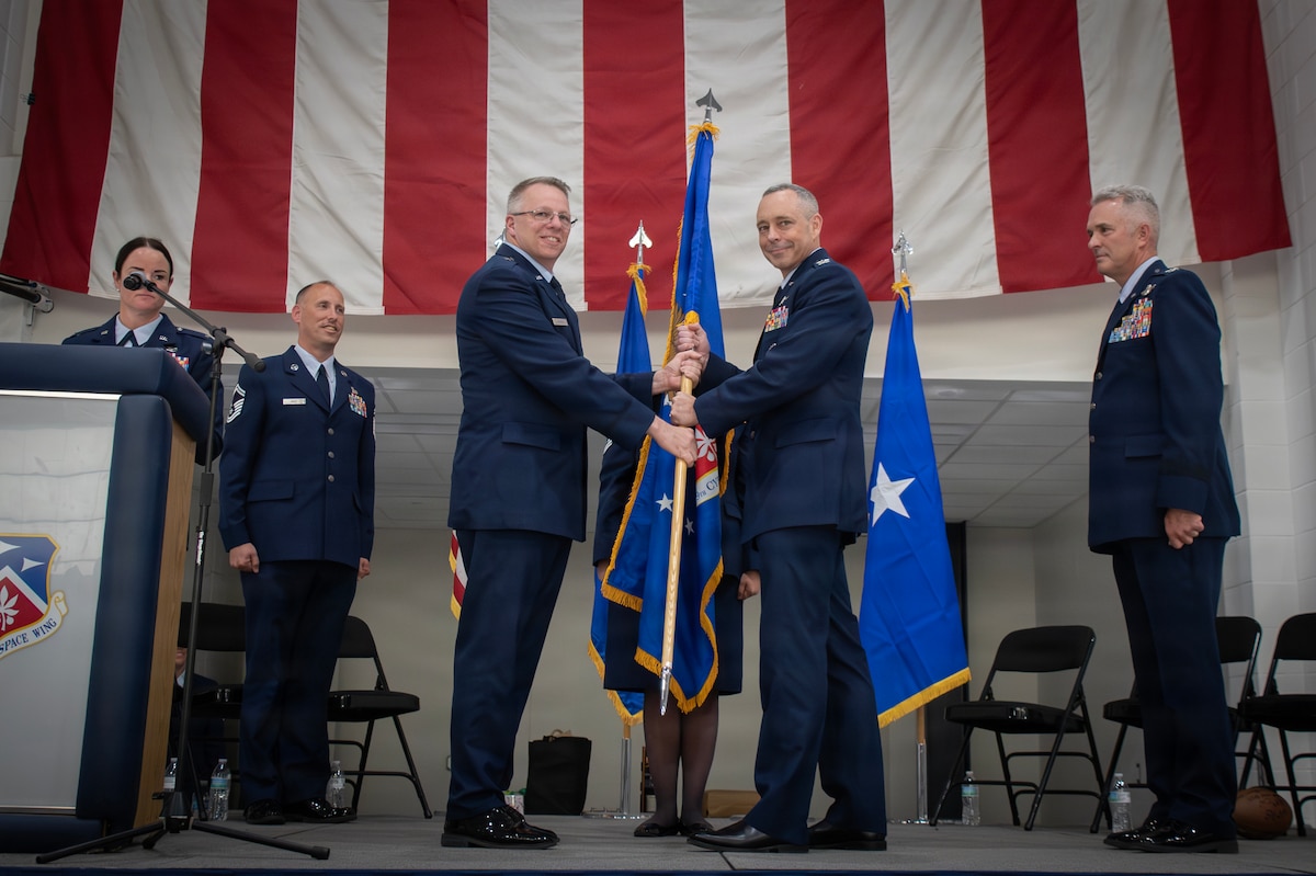 Col. Darren E. Hamilton relinquishes command of the 179th Cyberspace wing to incoming commander Col. Jack W. Johnson at the 179th Cyberspace Wing, Mansfield, Ohio, June 6, 2026. The 179th provides cyber-enabled capabilities supporting tactical needs in air superiority and information warfare, providing a competitive advantage in combat performance and survivability in joint force operations. (U.S. Air force photo by Tech Sgt. Alyssa Reik)